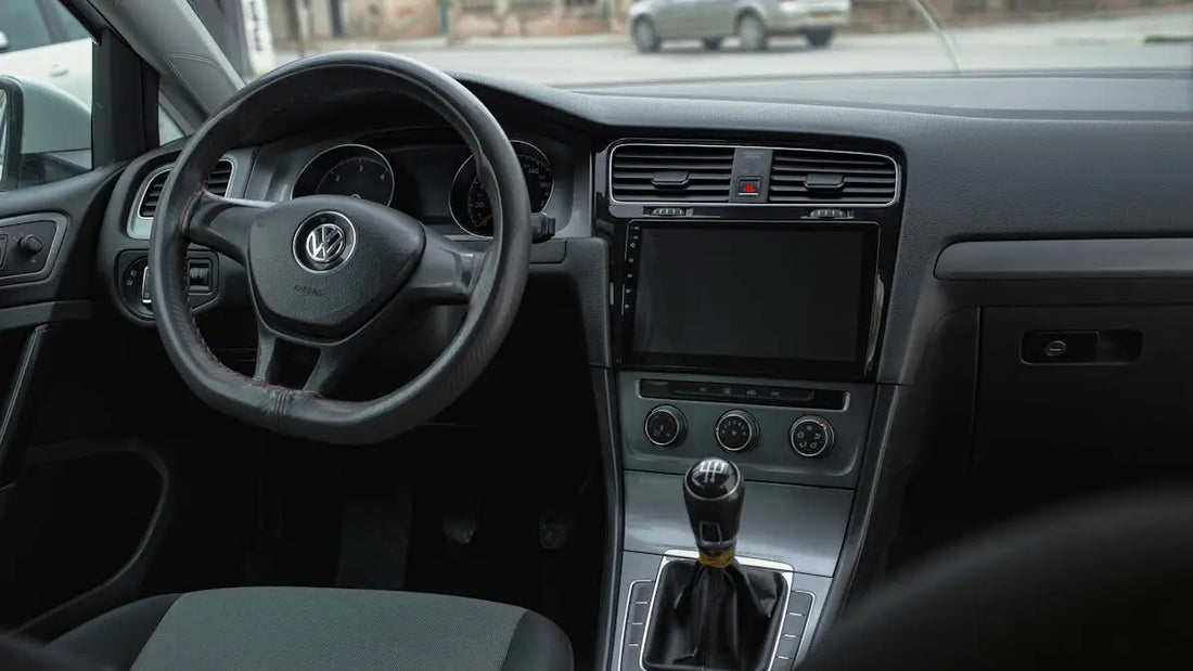 the interior of a car with a steering wheel and dashboard