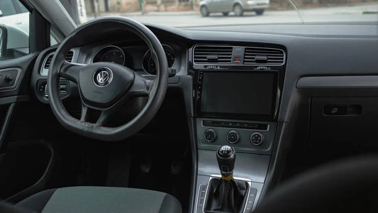 the interior of a car with a steering wheel and dashboard