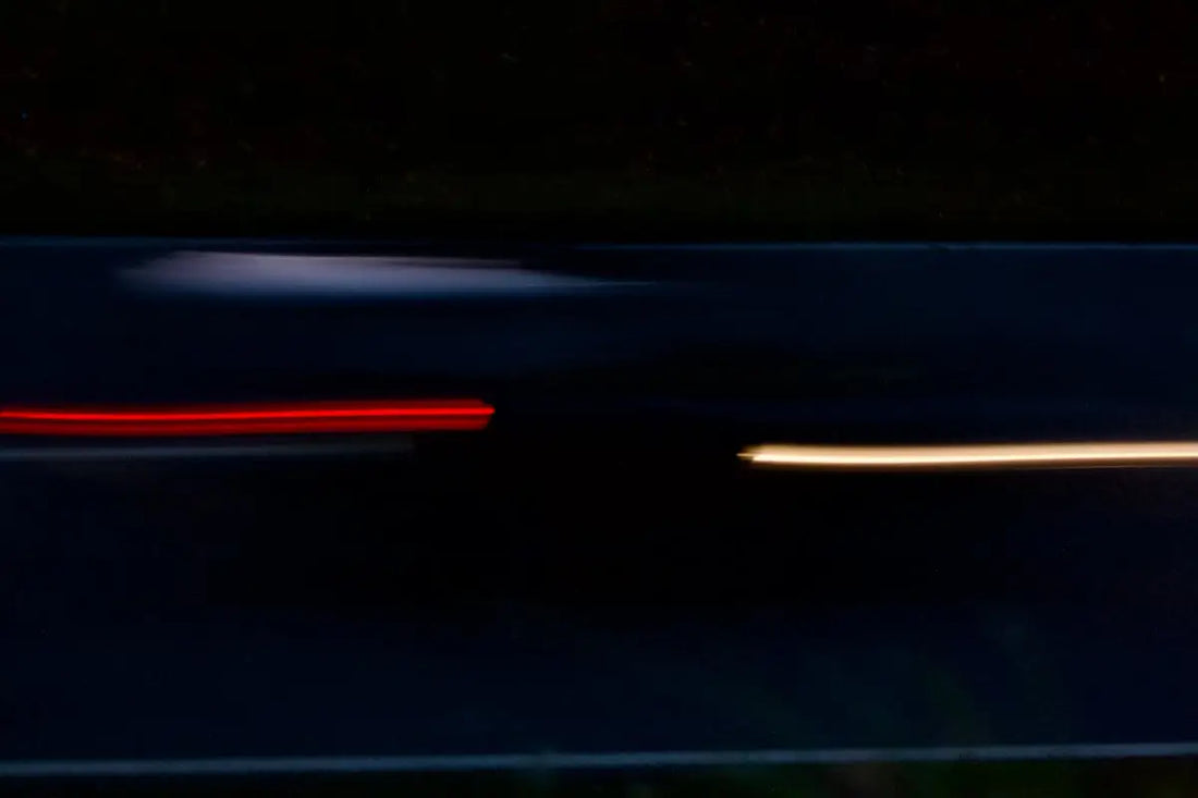 Light trails on a dark road at night
