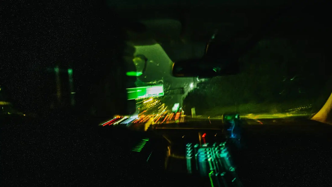 Blurred car lights on a dark road at night