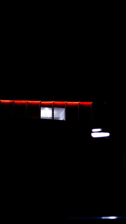 A building lit up at night with red lights