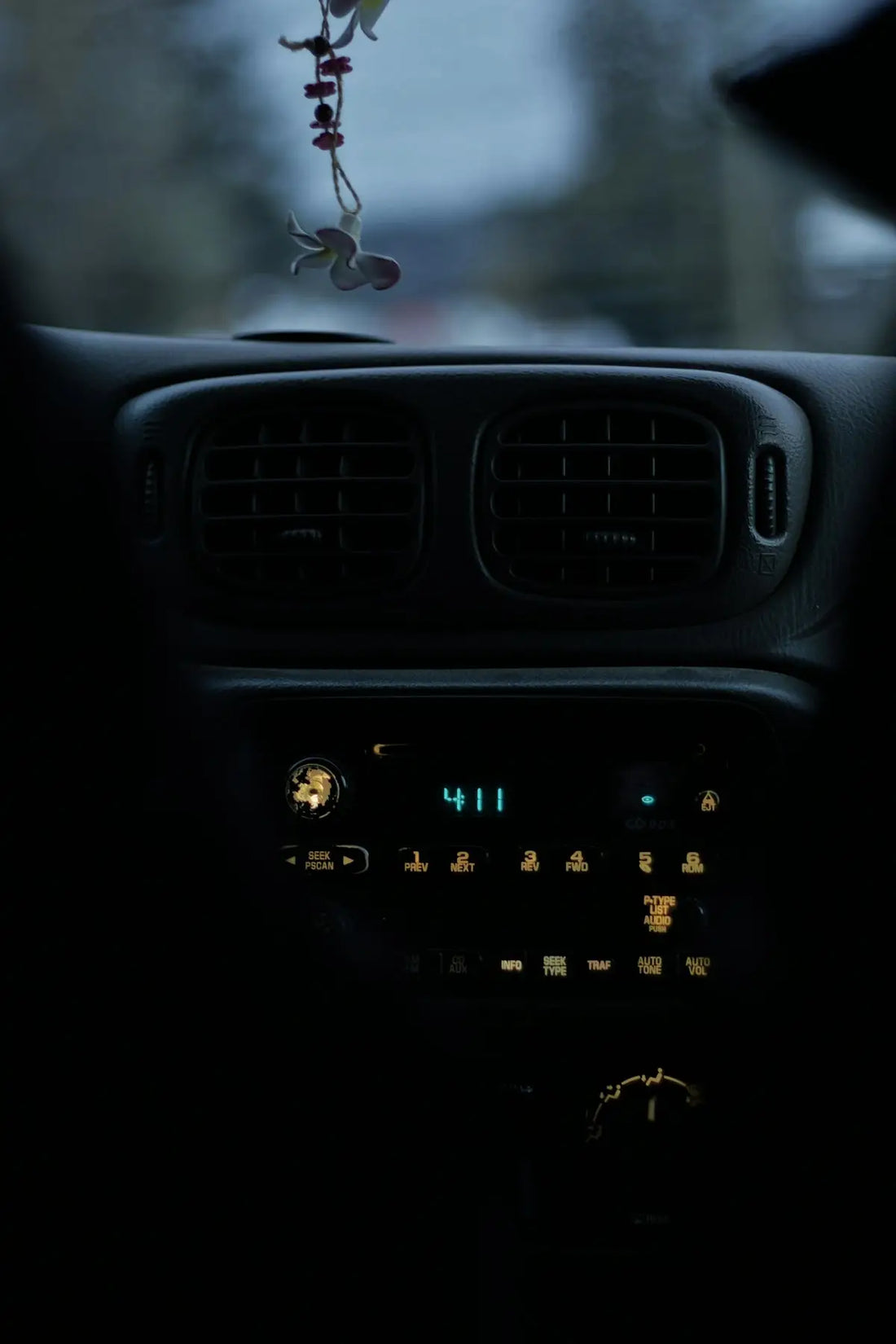 The dashboard of a car with a key chain hanging from it