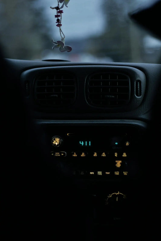 The dashboard of a car with a key chain hanging from it