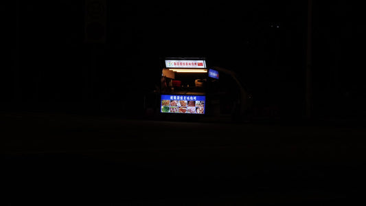 a vending machine lit up at night in the dark