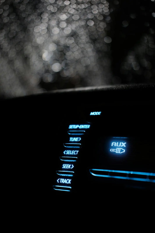 A close up of a car dashboard with the lights on