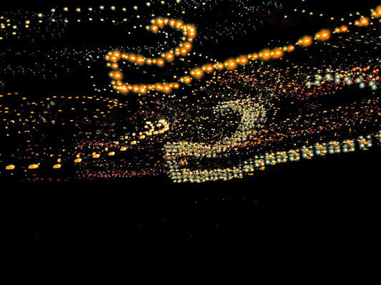 a picture of a car driving down a street at night