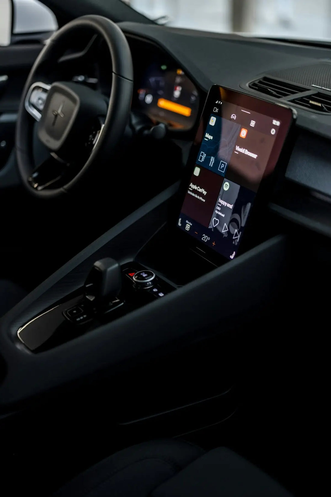 a car dashboard with a cell phone in the center