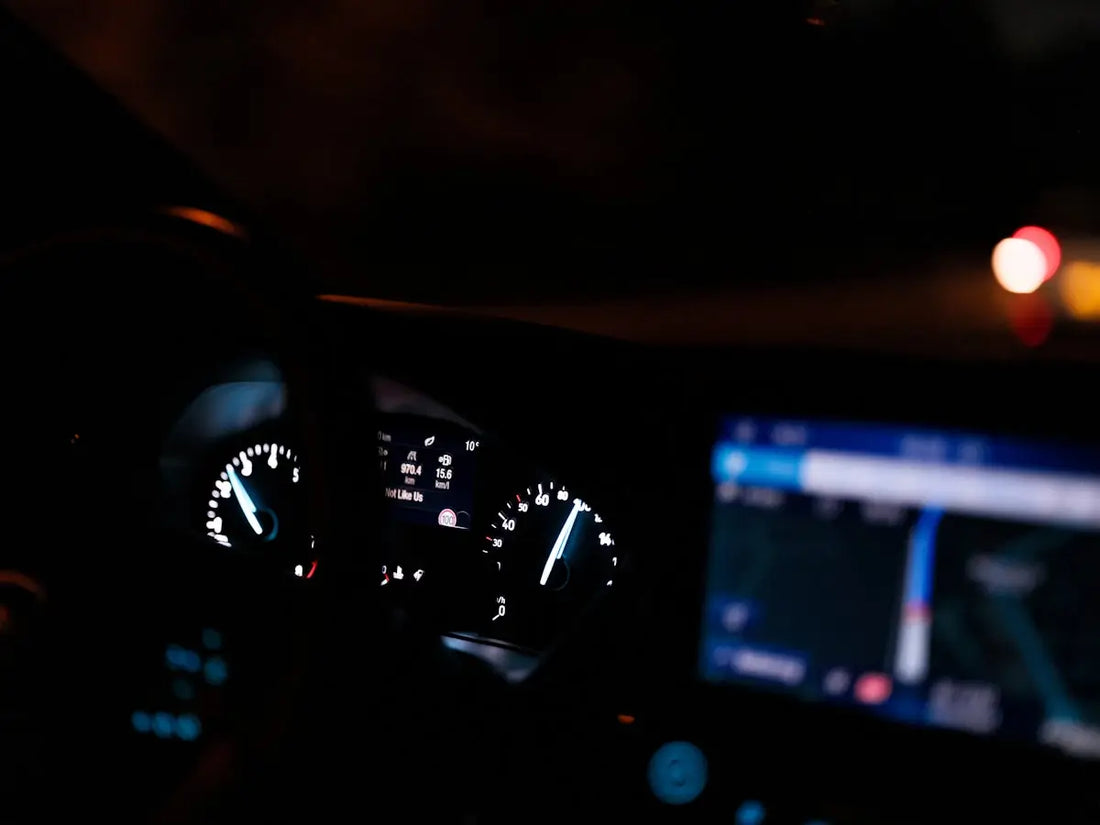 The dashboard of a car at night time