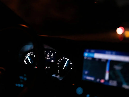 The dashboard of a car at night time