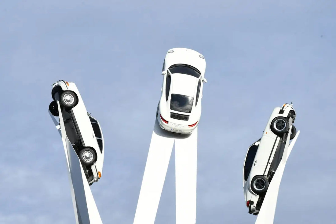 Three white cars are mounted in a circle.