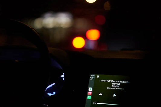 a car dashboard with a cell phone and headphones