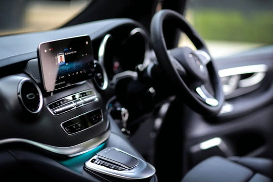 Interior view of a car's dashboard and steering wheel.