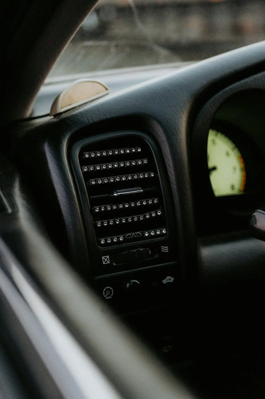 The dashboard of a car with a clock on it