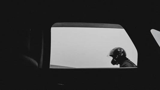 a black and white photo of a person wearing a helmet