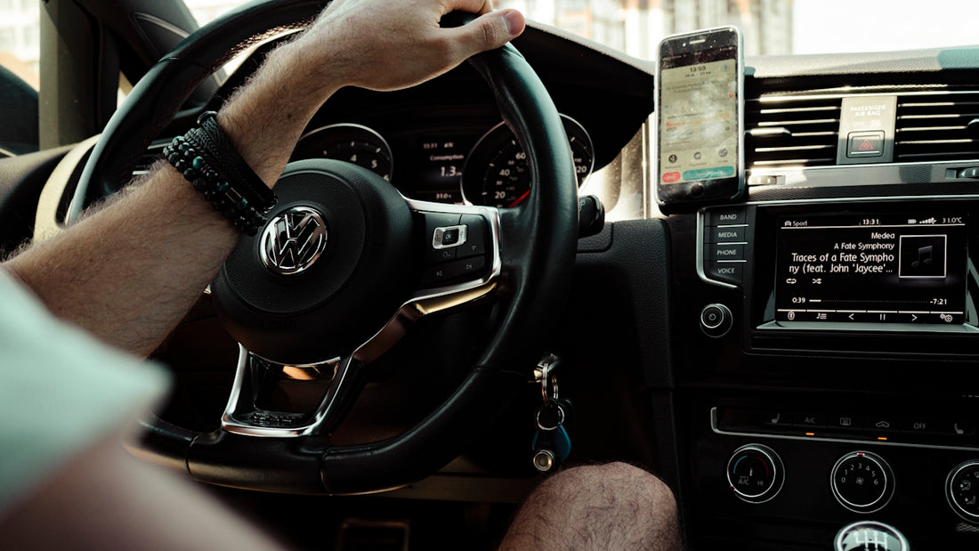 person holding black steering wheel