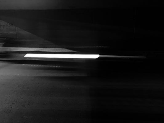 black and white road in a dark room