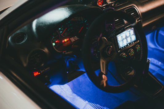 the interior of a car with a steering wheel and dashboard