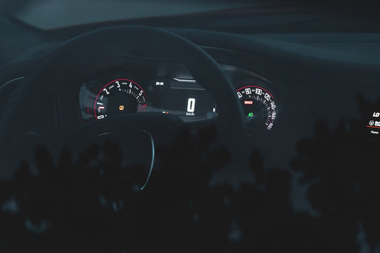 the dashboard of a car at night time