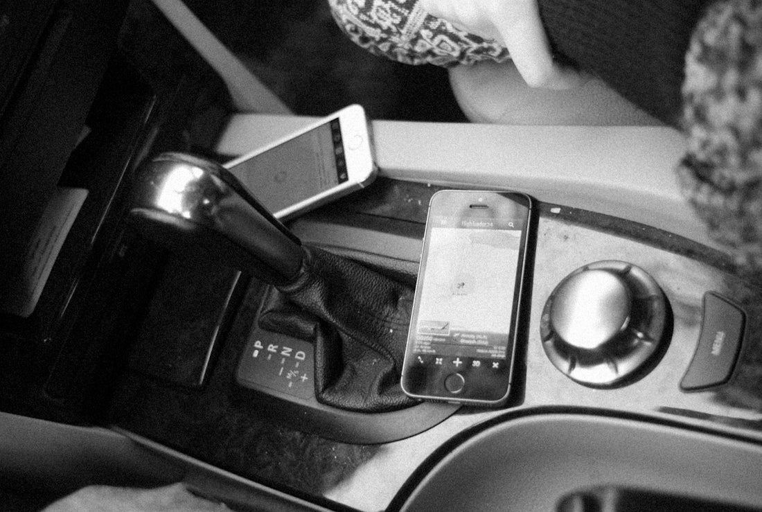 a car with a phone and other objects in it