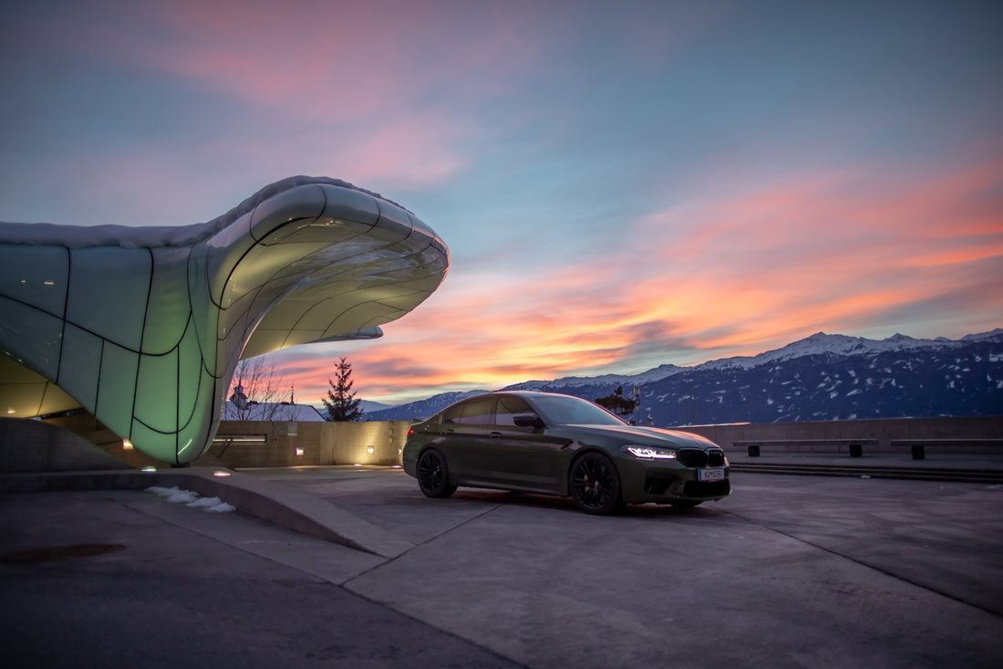 a car parked next to a large sculpture