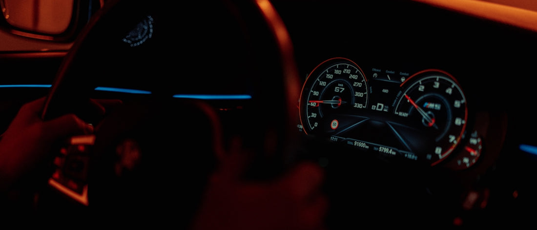 the dashboard of a car in the dark