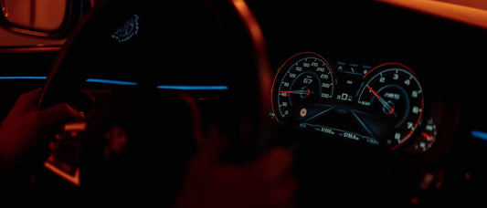 the dashboard of a car in the dark