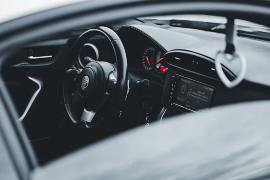 a close up of a steering wheel and dashboard of a car