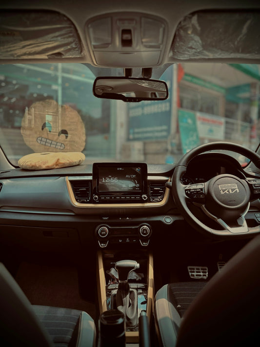 a car dashboard with a steering wheel and a radio