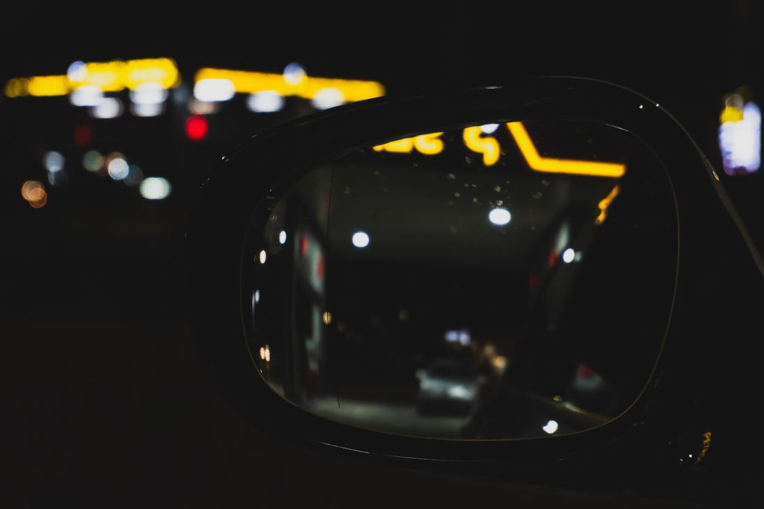 a car's side view mirror at night time