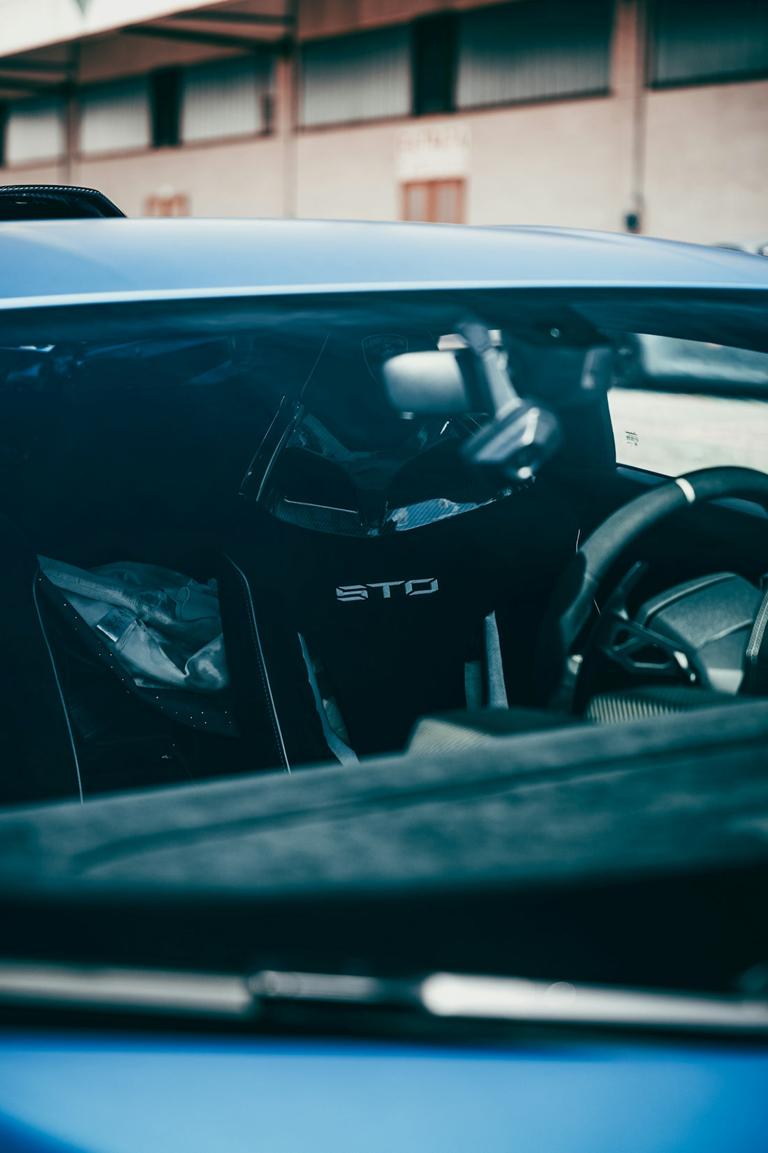 a car with its door open and a steering wheel out