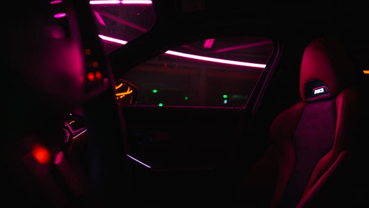 the interior of a car is lit up with red and green lights
