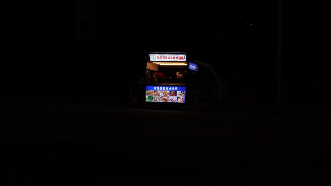 a vending machine lit up at night in the dark