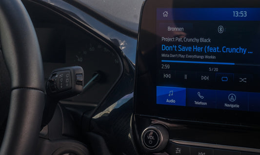 A close up of a car dashboard with an electronic device
