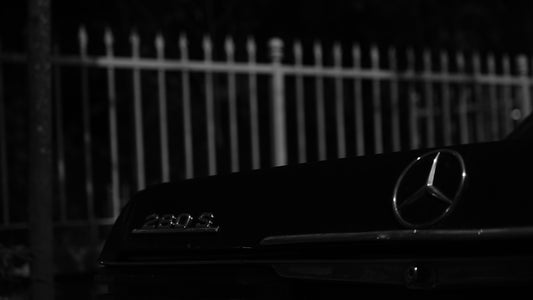 A black and white photo of a mercedes car