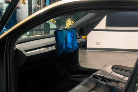 A picture of a man's face on a monitor in a car