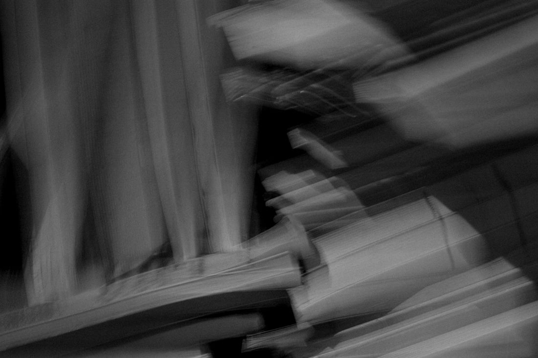 A blurry photo of a person sitting on a bench