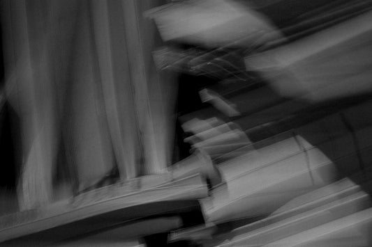 A blurry photo of a person sitting on a bench