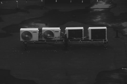 A couple of air conditioners sitting next to each other