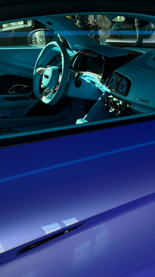 An interior view of a blue sports car.