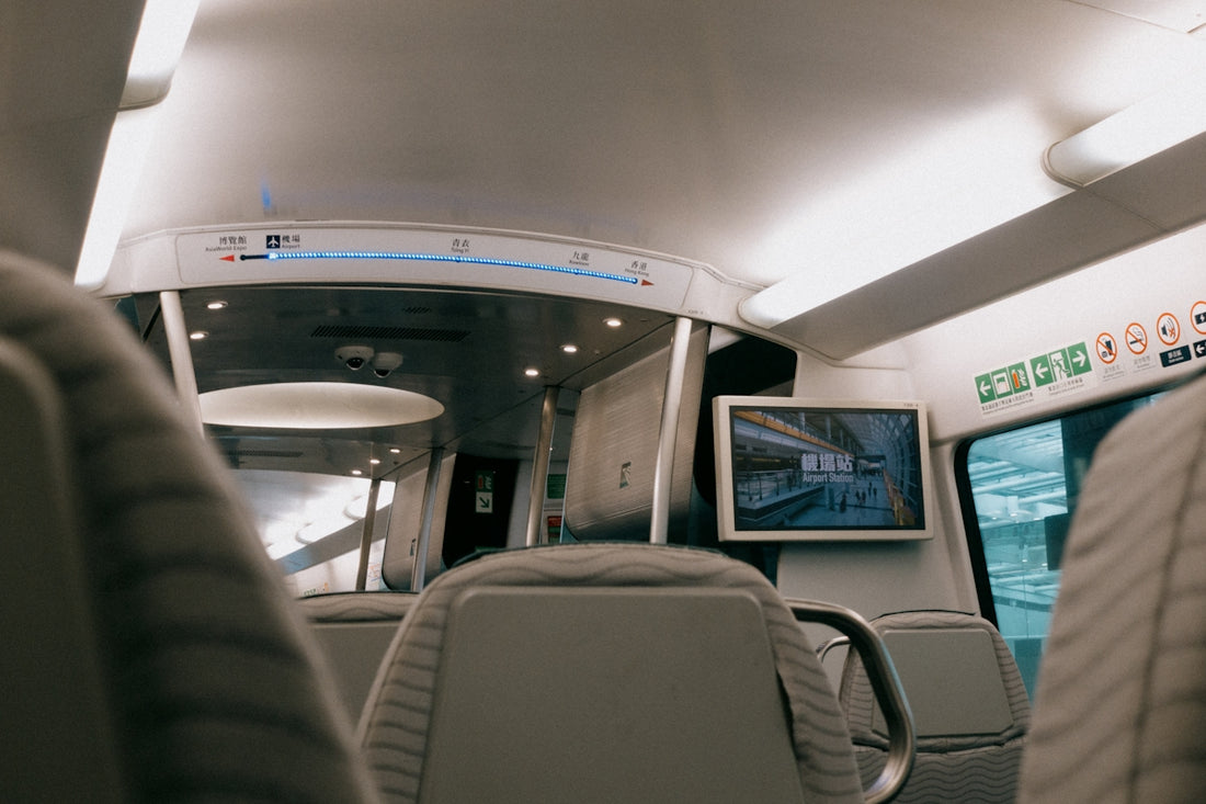 Inside a modern train car with seating.