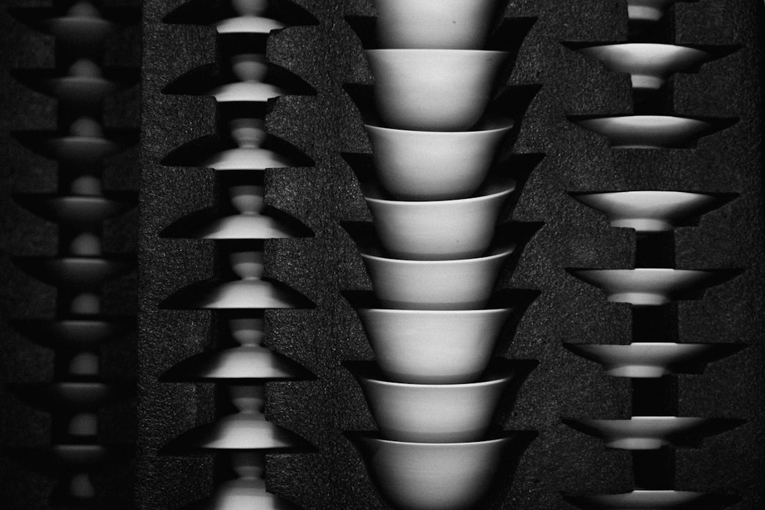 Stacked ceramic bowls and abstract shapes in rows.