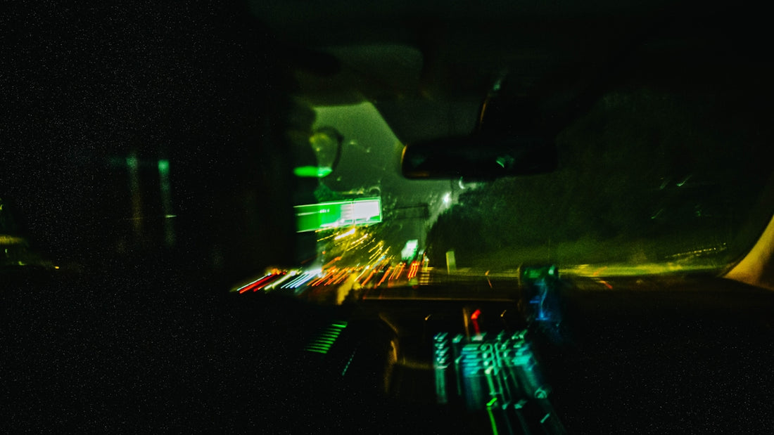 Blurred car lights on a dark road at night