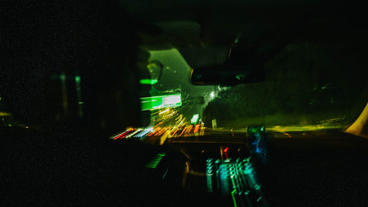 Blurred car lights on a dark road at night