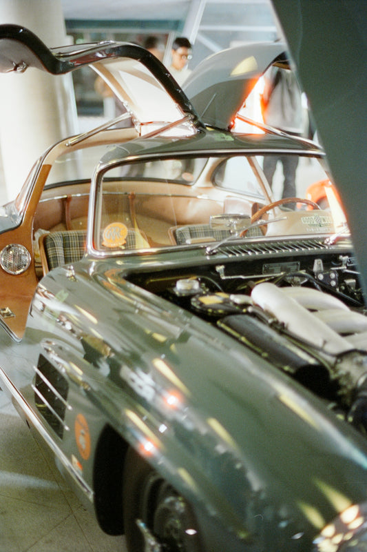 Classic gullwing car with open hood and doors
