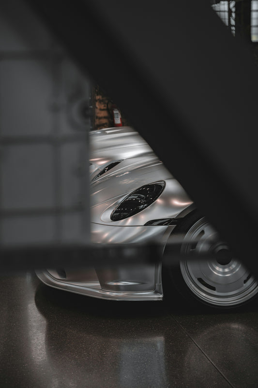 Sleek silver sports car with unique headlights