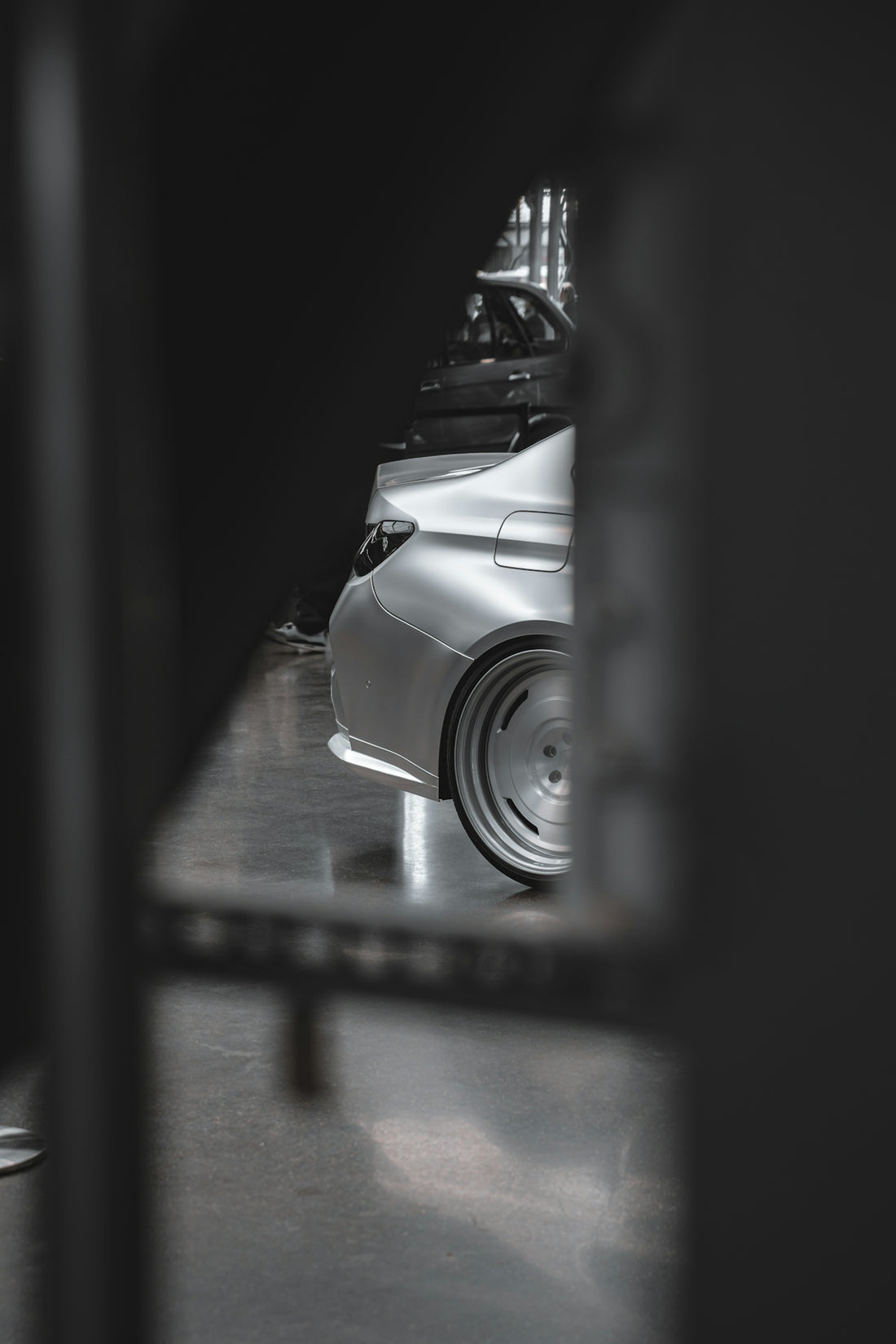 Silver car's rear wheel and bodywork