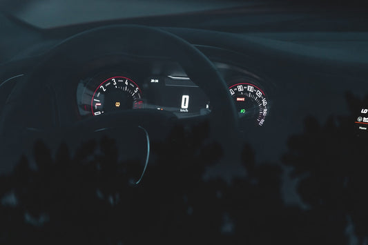 the dashboard of a car at night time