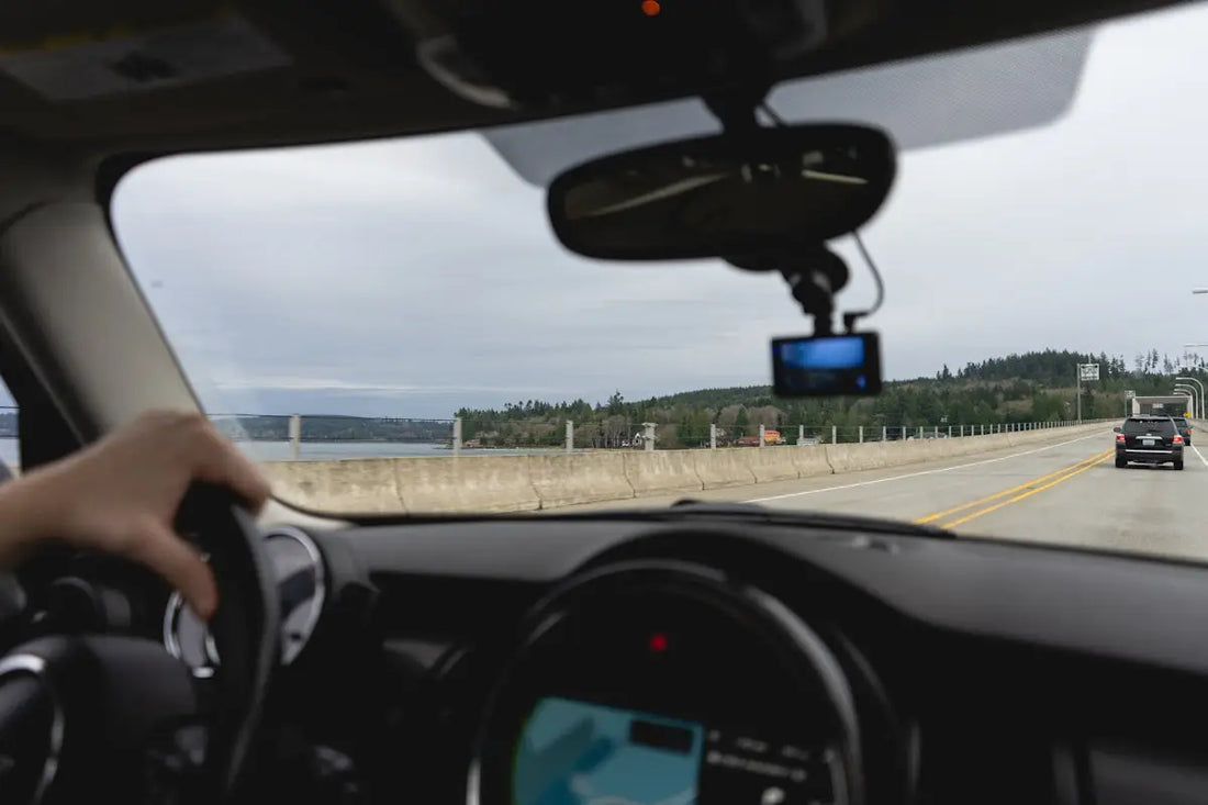 a person driving a car on a highway