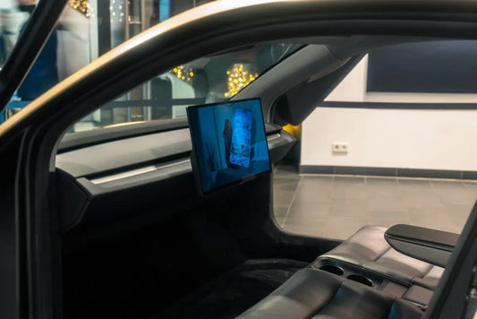 A picture of a man's face on a monitor in a car