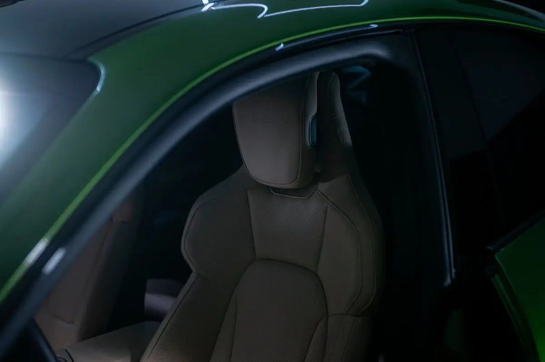 The interior of a green sports car with its lights on